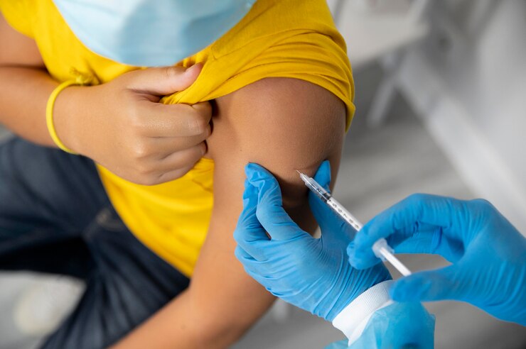 Person receiving travel vaccines injection before traveling